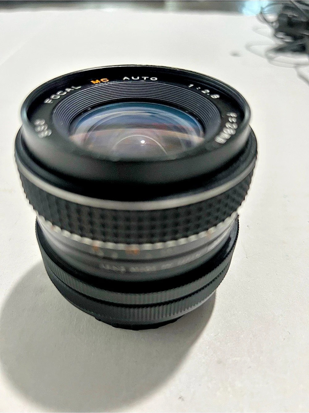 Focal MC Auto 28mm f/2.8 wide-angle camera lens with a manual focus ring